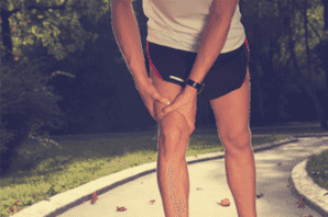 man holding knee during exercise